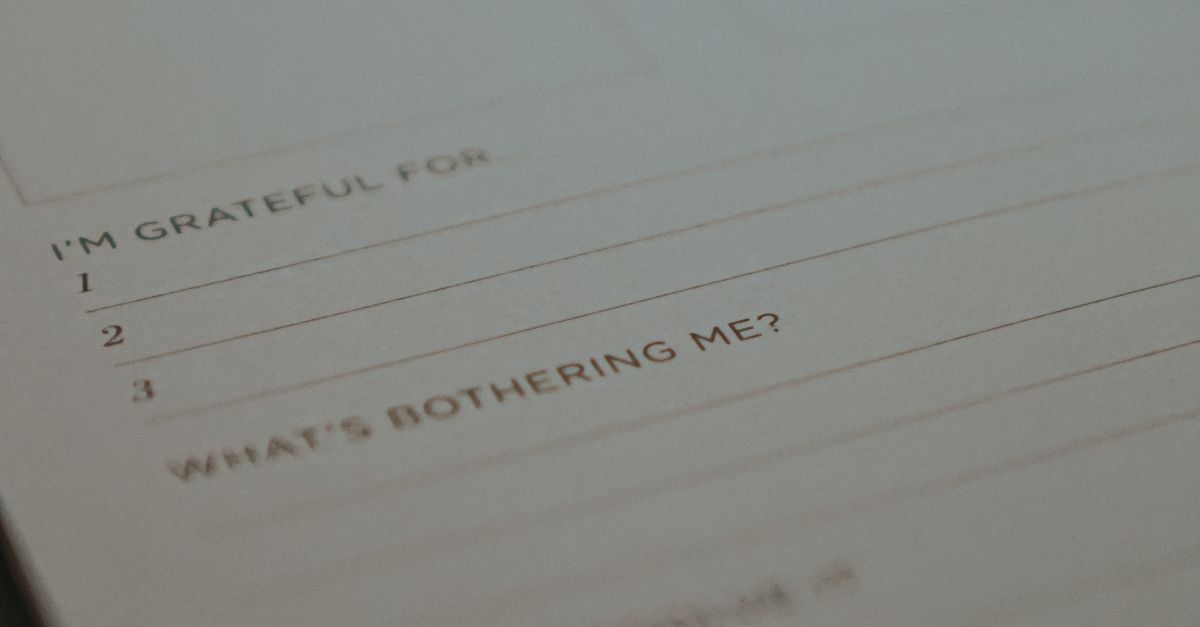 A close-up of an open journal featuring gratitude and reflection prompts, ideal for mental health mindfulness.