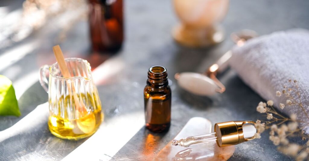 Aromatic oils and spa tools arranged on a table, perfect for relaxation.