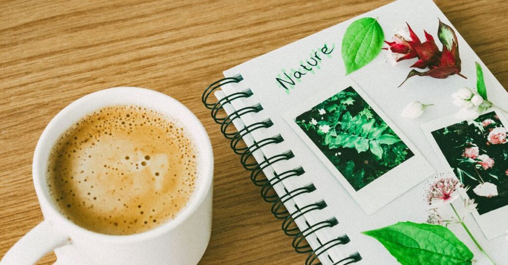 A calming still life image featuring a coffee cup and a nature-themed notebook on a wooden table.