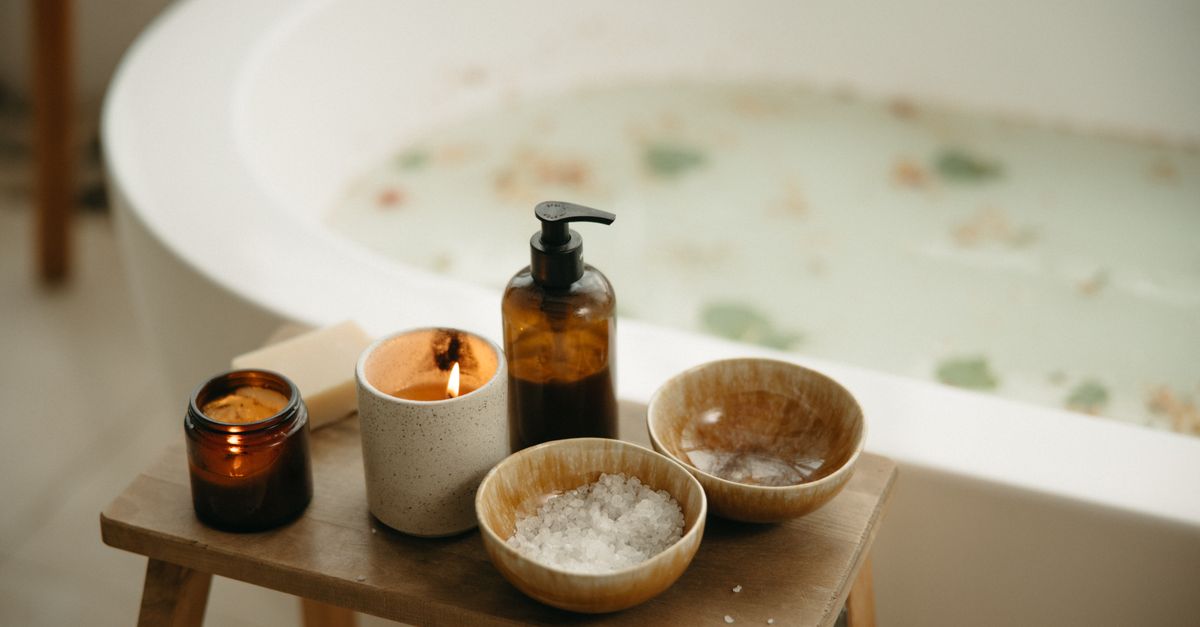 Tranquil bath setting with candles and bath salts, perfect for relaxation and beauty care.