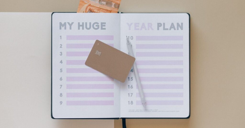 Open planner with a credit card and pen, perfect for financial planning visuals.