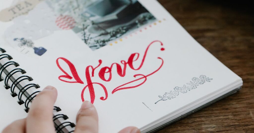 A close-up shot of hands holding an open journal with 'love' handwritten on a page.