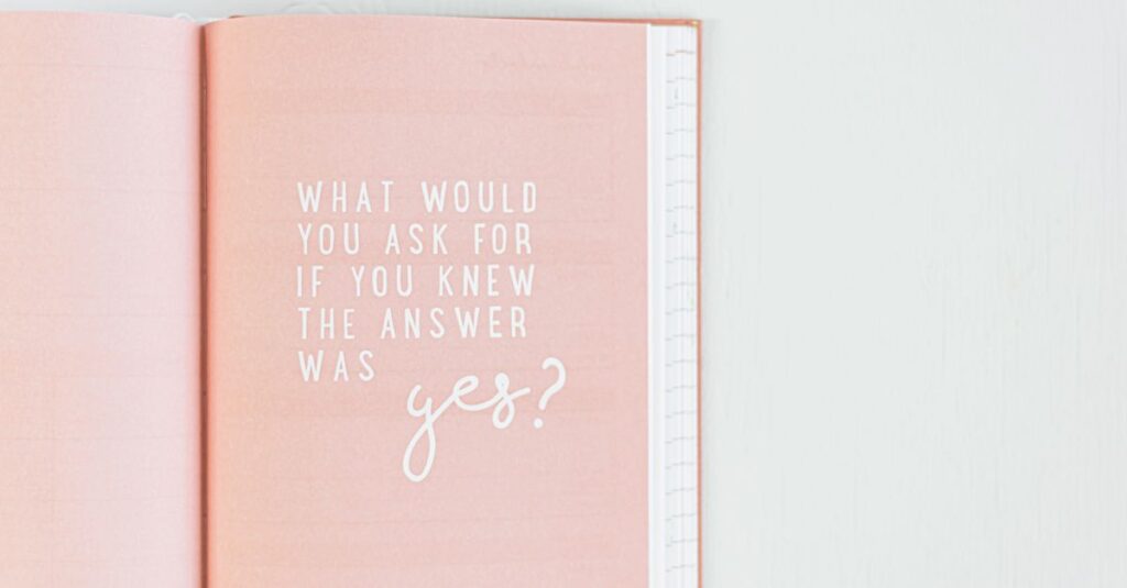 Open pink notebook with an inspirational quote in white text.
