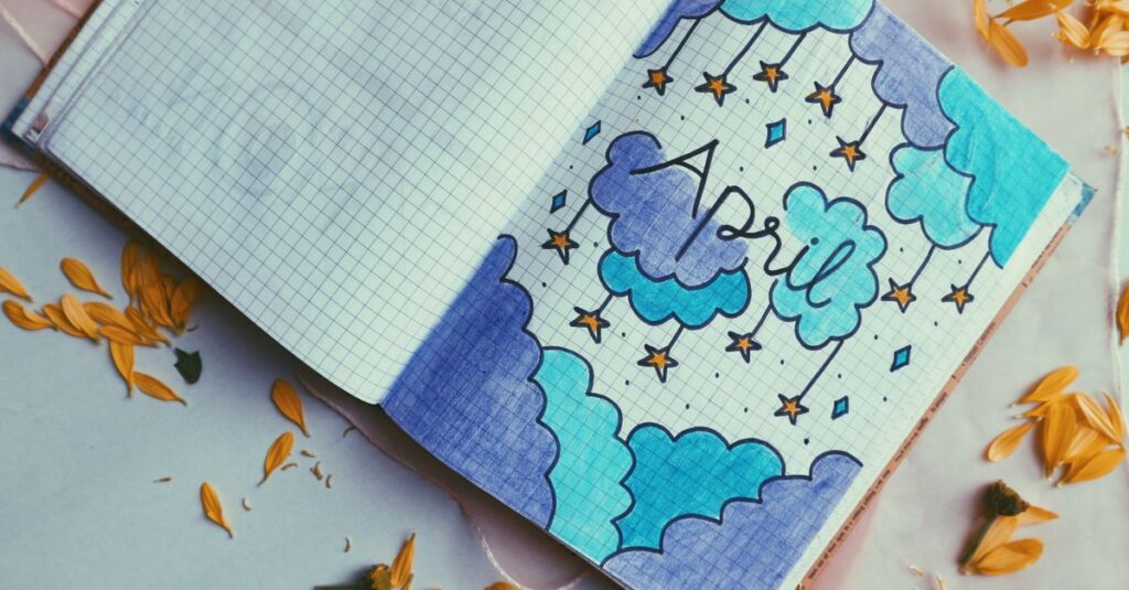 Artistic notebook page design featuring April theme and heart illustration, surrounded by petals.